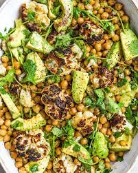 Roasted Cauliflower Chickpea And Avocado Salad With Cumin Fresh Coriander Olive Oil And Lots Of Fla Roasted Cauliflower Salad Avocado Salad Deliciously Ella