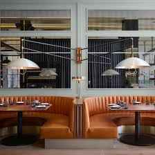 Mid Century Style Lamps Swivel Above Burnt Orange Leather Booths Inside This Restauran Banquette Salle A Manger Mobilier Restaurant Design Interieur Restaurant