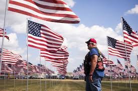 Jeff Kahl Of Cedar Rapids Iowa Walks Through Rows Of American Flags Thursday In The Milita Sturgis Motorcycle Rally Motorcycle Rallies Buffalo Chip Campground