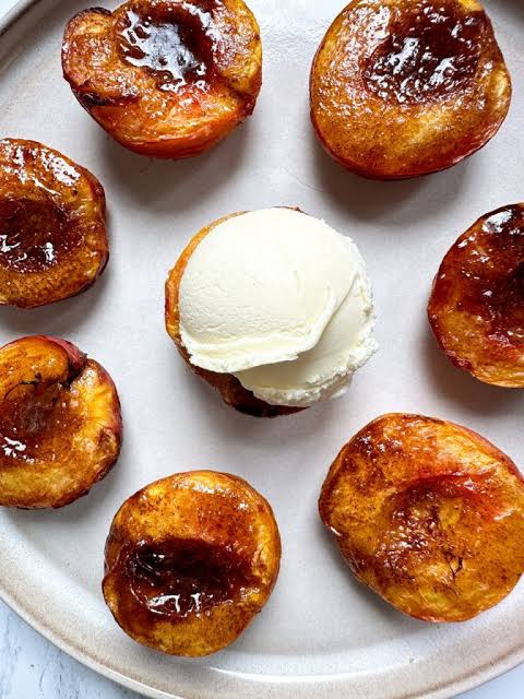 Sweet Cinnamon Air Fryer Peach served with a scoop of vanilla ice cream