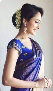 What A Beautiful Low Bun With Real Flower Gajra Care However Should Be Taken Before Adopting Such Hairstyles Bun Hairstyles Bridal Hair Buns Trendy Hairstyles