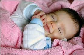 Sleeping sweet baby wearing funny striped stock photo. Pin On áƒ¦ Babies Smiling In Their Sleep So Precious áƒ¦