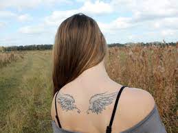 This back piece angel wing tattoo is magnificently done. Small Angel Wings Tattoos 24 Dainty Collections Design Press