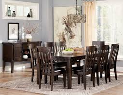 This dining room displays a charismatic nordic theme with bright chairs surrounding a minimalistic wood table, a pegboard offering flexible storage in the background. Dark Wood Dining Room Sets Off 63