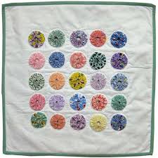 So that is how to make a fabric yoyo and how you can use fabric yoyos in your life. Yoyo Bliss Doll Quilt Learn How To Sew A Doll Quilt