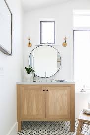 Farmhouse Bathroom With Black And White Cement Tile White Oak Vanity Round Metal Mirror And Brass Glass S Farmhouse Vanity Farmhouse Bathroom Trendy Bathroom