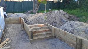 Pine Sleeper Retaining Wall With Stairs Prior To Backfilling And Staining Landscaping Retaining Walls Backyard Retaining Walls Sleeper Retaining Wall
