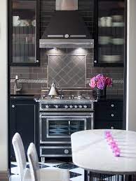 Modern white kitchen boasts rh 1940s vintage toledo barstools placed on a dark stained wide plank wood floor at a white island finished with a white and. Black Kitchens Are The New White Hgtv S Decorating Design Blog Hgtv
