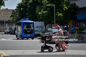Jean Kabre, R, talks with co-workers Justine Osborne, L, and Daniel... News  Photo