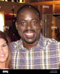 Minnesota Army wives Andrea Curely, Samantha Koktan and Tammy Estes pose  with Sterling K. Brown who plays Roland Burton