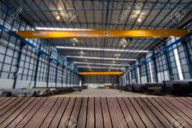 You can use it to store your trucks or house a big contractor! Wood Table Top On Blur Factory Hall Or Garage Background Stock Photo Picture And Royalty Free Image Image 64663732