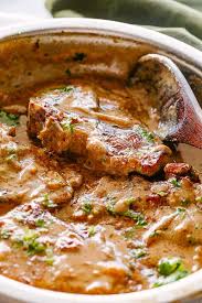 Smothered Pork Chops Juicy And Delicious Pan Seared Pork Chops Cooked In A Rich Onion Smothered Pork Chops Recipe Pork Chops And Gravy Pan Seared Pork Chops