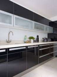 The space features stainless steel appliances and cabinetry, hardwood floors and monochromatic countertops. Sleek Photos 3 Of 23