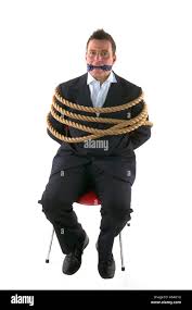 Businessman tied up with rope and gagged with his own tie isolated on a  white background Stock Photo - Alamy