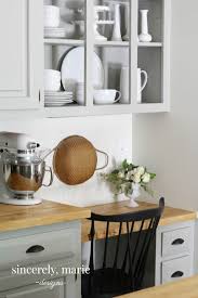 Hold each lid up to the cabinet door and place command hooks at 8:00 and 4:00 (pretending your lid is a clock face). Kitchen Cabinets Vs Opening Shelving Thoughts On Both