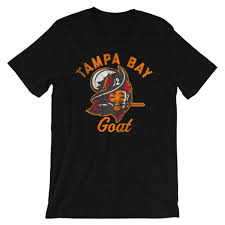 With snoopy as joe cool wearing a shirt with the logo of the tampa bay buccaneers while leaning on the protection. The Tampa Bay Goat Tampa Bay Buccaneers Tom Brady Inspired Unisex T Sh Atx Humor