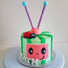 This customised cake is frosted with green buttercream. Cocomelon Cake The Baking Experiment