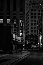 Black And White Building Pictures Hd Black And White Night Shot Of Diner Sign Surrounded By City Buildings In Financial District Diner Sign Black And White City Photo