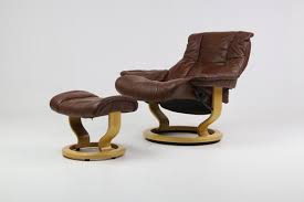 Artificial leather has peeled slightly on one section of the chair on the left as seen in pictures. Relax Armchair With Ottoman In Brown Leather From Ekornes Set Of 2 For Sale At Pamono