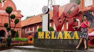 It is one of the places that have a high concentration of tourists as most of the tourist attraction is located in this area. Bandar Hilir Melaka A Zjune 28 A Z2019 A Beautiful Tourist With An Umbrella Taking A Picture In Front Of I Love Melaka Logo At Bandar Hilir During The Rainy Day Lizenzfreie