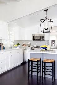 A White Sloped Ceiling Stands Over A White Shaker Kitchen Cabinets Paired With Marb Vaulted Ceiling Kitchen White Shaker Kitchen Cabinets Kitchen Remodel Small