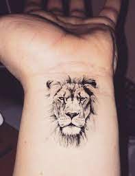 24 Small Lion Tattoo Designs And Ideas Wrist Tattoos For Guys Small Lion Tattoo Cool Wrist Tattoos