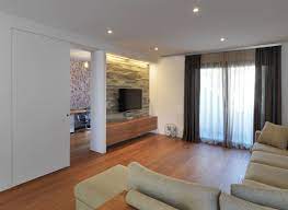 Amusing Design Ideas Of Living Room With L Shape Colored Sofas And Tv On Wall Also Stone Wall Layers An Interior Wall Design Rustic Media Cabinets House Design