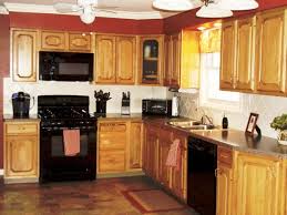 The cabinets were personalized with red door pulls. Kitchen Color Ideas With Oak Cabinets And Black Appliances Black Appliances Kitchen Kitchen Cabinets With Black Appliances Rustic Kitchen Cabinets