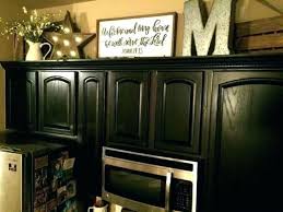 Finish decorating your kitchen with a rustic clock, coasters, canister sets, and cookie jars. Ideas For Kitchen Cabinets On Top Decorations Top Kitchen Cabinets Decor Decorating Above Kitchen Cabinets Kitchen Cabinets Decor