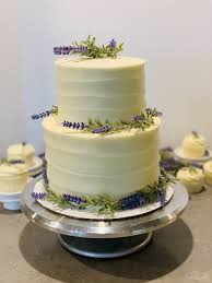 A wedding cake with white swirls and lavender lilies. Vanilla Lavender Wedding Cake Intensive Cake Unit