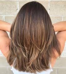 Women with round faces will appreciate the way a medium haircut with bangs and angled layers elongates and slims down the face. Medium Length Hair In Layers That Will Inspire Your New Haircut