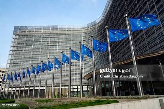 The European Union flag flying outside the EU headquarters building.