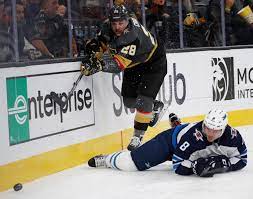 Vegas Golden Knights Left Wing William Carrier 28 Battles For The Puck With Winnipeg Jets Defenseman Jacob Trouba Golden Knights Vegas Golden Knights Knight