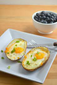 Baked Eggs In Potato Skins 2 Large Baked Potatoes Already Fully Cooked And Cooled 1 4 C Cheddar Cheese 4 Eggs 2 Green Onions Potato Skins Recipes Food