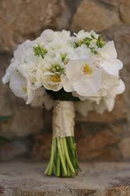 Available in white, yellow, pink, lavender, magenta, and orange, this small blossom has a subtle scent which will not overpower your bouquet. Elena Damy White Bridal Bouquet With Orchids Freesia Peonies Elena Damy Chris Lynn Photographers Elena Damy