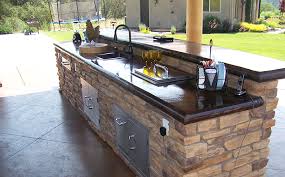 One idea we like is choosing a unique tile for your outdoor kitchen backsplash to contrast against your actual counters. Outdoor Kitchen Concrete Countertop Custom Image Hardscape