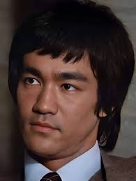 Bruce Lee was a martial arts legend and one of the most prominent symbols  of popular culture. In this photo, Bruce Lee appears with a serious  expression, reflecting his deep thought and