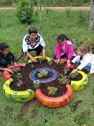 After you paint your tire, drill the bottom of the tire to make a few drainage holes, just like you did in the tree stump planter project. Diy Made Of Old Tires Tire Garden Plants Gardening For Kids
