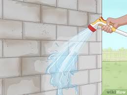 A cinder block alloy garden looks nice in front of a house with a modern design. 4 Ways To Cover Exterior Cinder Block Walls Wikihow