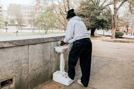 man assembles handwashing stations for