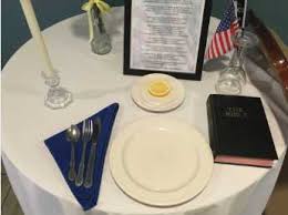 The single rose displayed in the vase reminds of their families and loved ones who keep faith in their return. Wyoming Air Force Base To Replace Bible On Pow Mia Table With Generic Book Of Faith Following Complaint Christian News Network