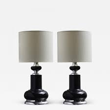 Pick up a set of table lamps with decorative lamp shades that you can swap out according to season or holiday to keep things fresh. Pair Of 1980s Black Table Lamps With Metallic Accents