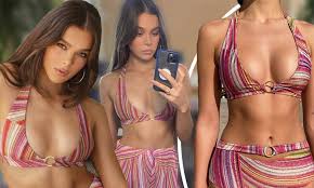 Hailee Steinfeld flashes her abs in a bikini top as she shares a  behind