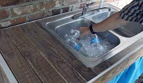 Last month, my handy husband put together an outdoor sink for the homestead using an old stainless steel double basin our neighbors were throwing away. How To Build An Outdoor Sink