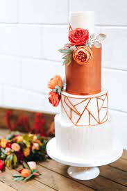 Copper Geometric Wedding Cake With Orange And Red Sugar Flowers And A White Bark Effec Contemporary Wedding Cakes Geometric Wedding Cakes Romantic Wedding Cake