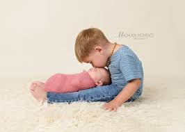 Sweet Newborn Baby Girl In Pink With Her Big Brother Kissing Her During Her N Baby Girl Newborn Photos Baby Girl Newborn Pictures Newborn Baby Girl Photography