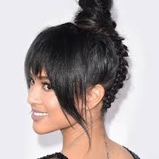 This cool style features an undercut with geometric hair design and wavy hair pulled into a high bun up top. 10 Cool And Easy Buns That Work For Short Hair