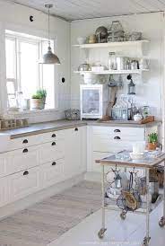 A peaceful nordic kitchen with sleek white cabinets, concrete countertops, olive green walls and upper cabinets is a chic space a rustic industrial kitchen in grey, with a long shelf instead of upper cabinets, concrete coutnertops and metal pendant lamps Concrete Countertops 2 Country Kitchen Decor Kitchen Renovation Kitchen Remodel