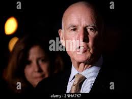 California Governor Jerry Brown joined by his wife Anne Gust-Brown, as he  speaks to the news media in front of the Governor's Mansion near the State  Capitol