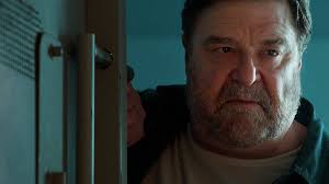 He's flannel clad, baseball cap wearing, and has a beard that would make most men jealous. 10 Cloverfield Lane Netflix